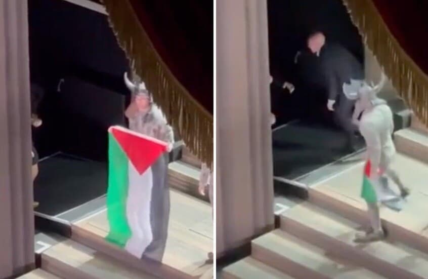 فشلوا في انتزاعه منه.. فنان يرفع علم فلسطين على مسرح دار الأوبرا الملكية في بريطانيا